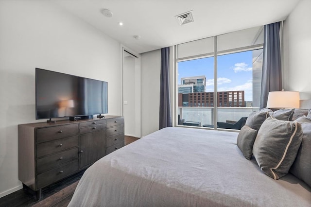 200 Congress Ave Unit 33Bb, Austin, TX 78701 - bedroom featuring expansive windows, dark wood finished floors, and access to exterior