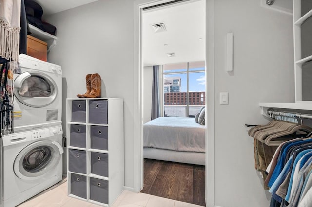 200 Congress Ave Unit 33Bb, Austin, TX 78701 - laundry room with estacked washer and dryer and tile patterned floors
