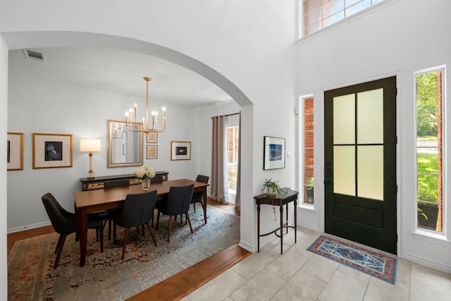 2308 Windswept Dr, Austin, TX 78738 - dining area with arched walkways, a chandelier, and wood finished floors