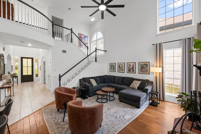 2308 Windswept Dr, Austin, TX 78738 - living area with a towering ceiling, a ceiling fan, arched walkways, light wood-style flooring, and plenty of natural light