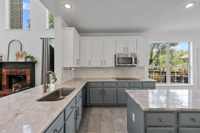 2308 Windswept Dr, Austin, TX 78738 - kitchen featuring gray cabinets, black appliances, light stone countertops, tasteful backsplash, and recessed lighting
