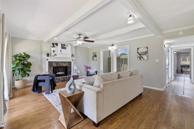 100 Lido Cir Unit B-1, Lakeway, TX 78734 - living area featuring beam ceiling, a fireplace, wood finished floors, a ceiling fan, and ornamental molding
