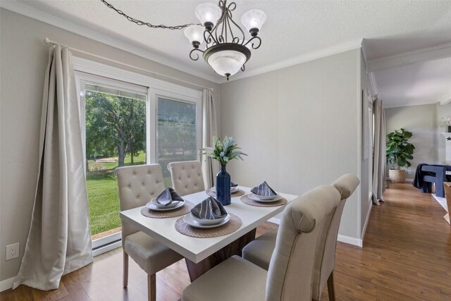 100 Lido Cir Unit B-1, Lakeway, TX 78734 - dining room featuring wood finished floors, a chandelier, crown molding, and a textured ceiling