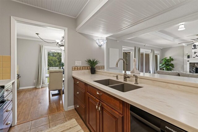 100 Lido Cir Unit B-1, Lakeway, TX 78734 - kitchen with dishwashing machine, light countertops, crown molding, beam ceiling, and light tile patterned floors
