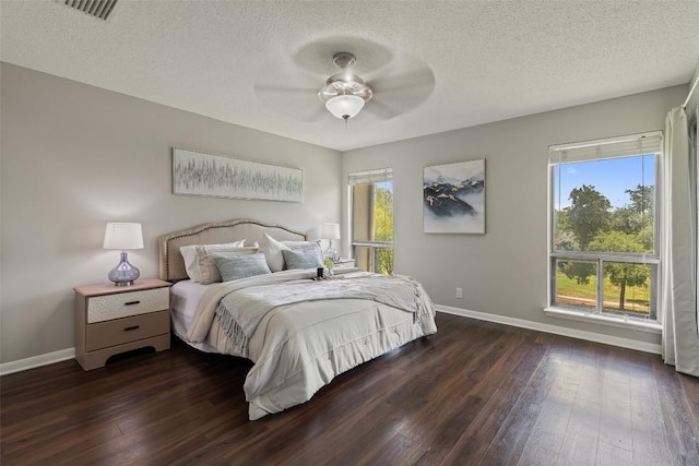 100 Lido Cir Unit B-1, Lakeway, TX 78734 - bedroom with multiple windows, hardwood / wood-style floors, a textured ceiling, and a ceiling fan