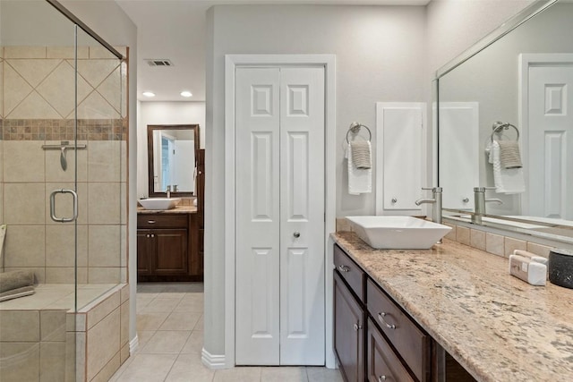 100 Lido Cir Unit B-1, Lakeway, TX 78734 - bathroom featuring tile patterned floors, a shower stall, vanity, a closet, and recessed lighting