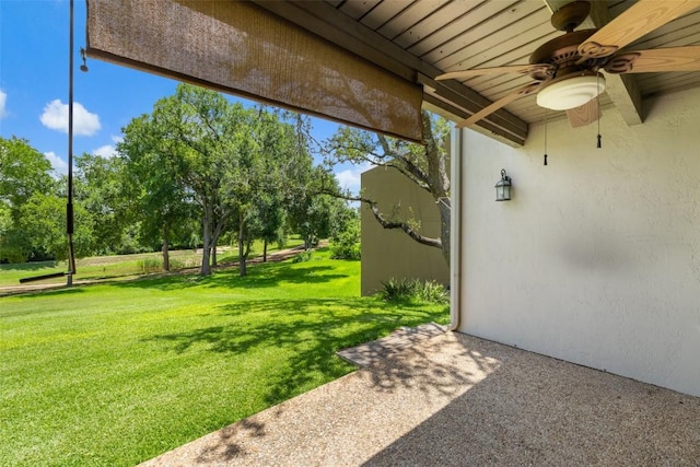 100 Lido Cir Unit B-1, Lakeway, TX 78734 - view of green lawn with ceiling fan and view of wooded area