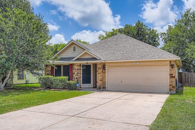 1229 Twin Cv, Kyle, TX 78640 - view of front of home with roof with shingles, an attached garage, stone siding, and concrete driveway
