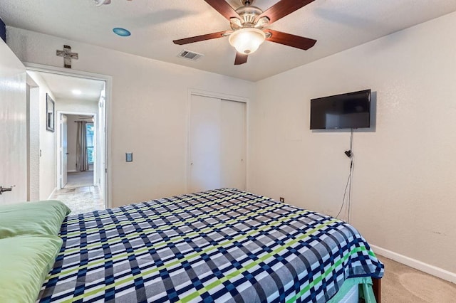1229 Twin Cv, Kyle, TX 78640 - bedroom with light carpet, a closet, and ceiling fan