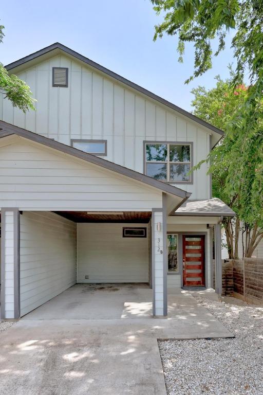 312 Delmar Ave Unit B, Austin, TX 78752 - view of front of property featuring board and batten siding, driveway, and a carport