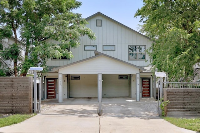 312 Delmar Ave Unit B, Austin, TX 78752 - view of front of house with board and batten siding, driveway, and an attached carport