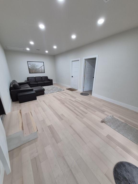 126 Deer Run Dr, Cedar Creek, TX 78612 - living area featuring light wood finished floors and recessed lighting