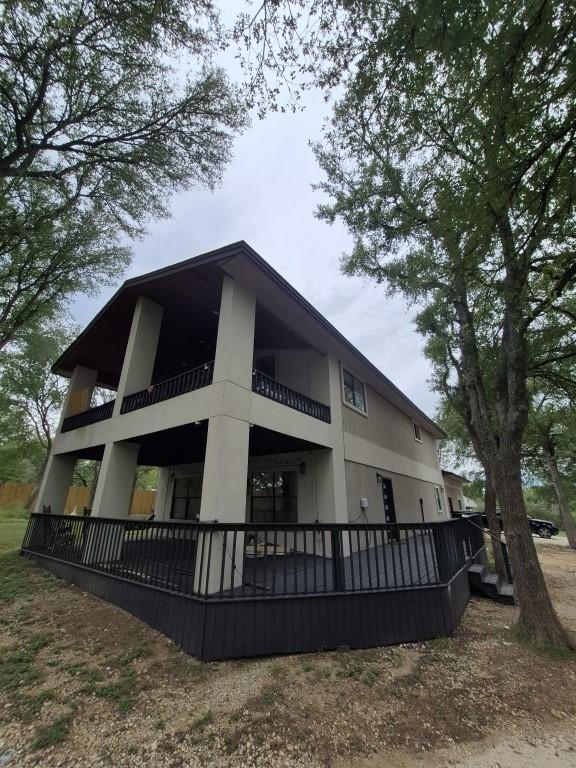 126 Deer Run Dr, Cedar Creek, TX 78612 - back of property with a balcony and stucco siding