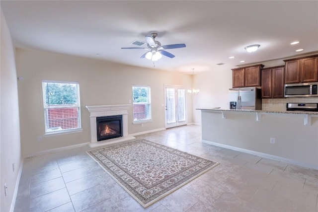 1416 Bichon Bnd, Austin, TX 78748 - kitchen featuring stainless steel appliances, a kitchen bar, tasteful backsplash, ceiling fan, and a chandelier