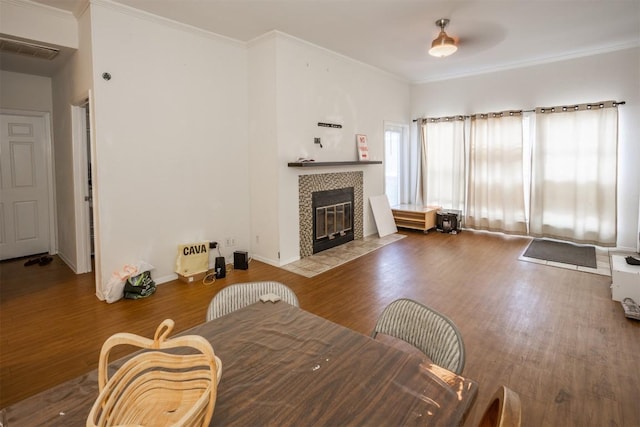 807 W 25th St Unit 102, Austin, TX 78705 - living area with wood finished floors, a tiled fireplace, and ornamental molding
