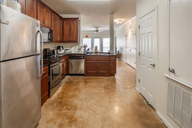 910 W 25th St Unit 403, Austin, TX 78705 - kitchen featuring appliances with stainless steel finishes, dark countertops, a peninsula, a ceiling fan, and concrete floors