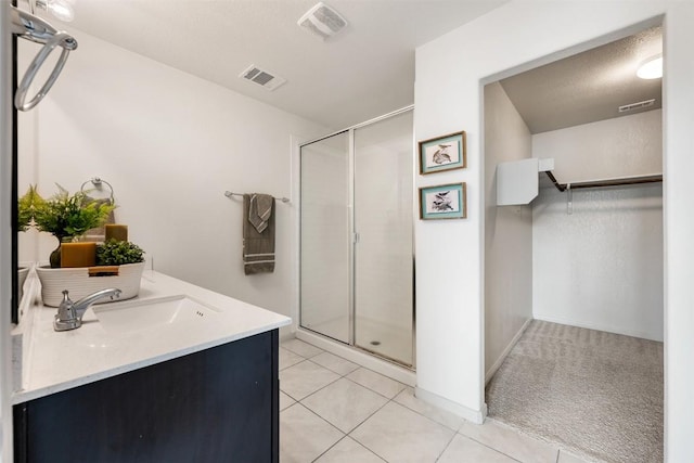 1116 La Conterra Blvd, Georgetown, TX 78626 - full bathroom with a shower stall, vanity, a spacious closet, and tile patterned flooring