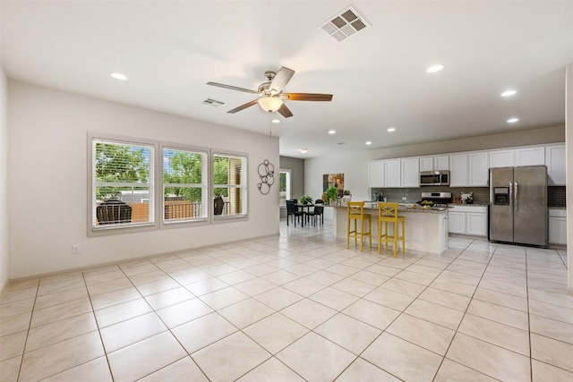 1116 La Conterra Blvd, Georgetown, TX 78626 - kitchen with stainless steel appliances, decorative backsplash, white cabinets, a ceiling fan, and recessed lighting