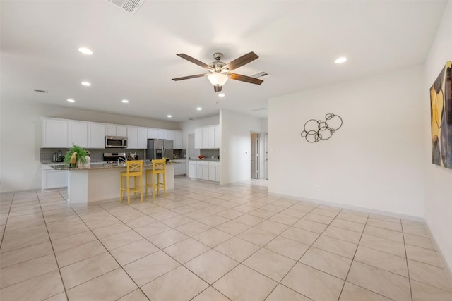 1116 La Conterra Blvd, Georgetown, TX 78626 - kitchen with appliances with stainless steel finishes, a ceiling fan, tasteful backsplash, recessed lighting, and white cabinetry
