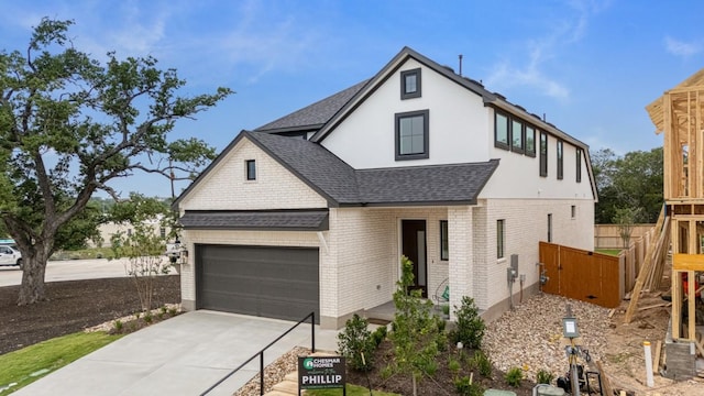 2705 Sage Ranch Dr Unit 19, Leander, TX 78641 - view of front of house with roof with shingles, brick siding, concrete driveway, and stucco siding