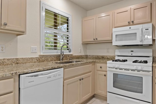 120 Plover Pass, Georgetown, TX 78633 - kitchen with white appliances, light stone counters, and light tile patterned flooring