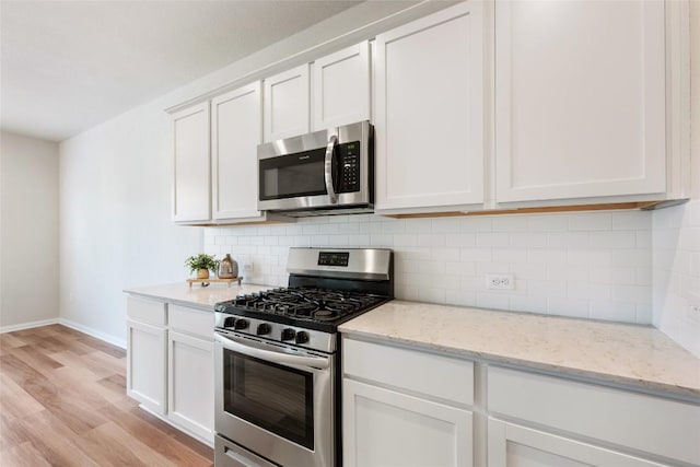 2533 Buffalo Ford Ct, Georgetown, TX 78628 - kitchen featuring stainless steel appliances, light wood-style flooring, tasteful backsplash, and white cabinetry