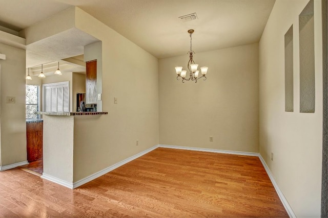 8200 Neely Dr Unit 116, Austin, TX 78759 - empty room featuring light wood finished floors and a chandelier