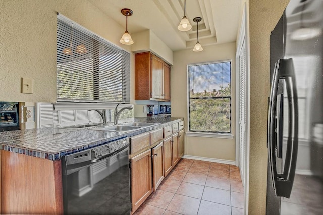 8200 Neely Dr Unit 116, Austin, TX 78759 - kitchen featuring dishwasher, a textured wall, freestanding refrigerator, dark countertops, and brown cabinets