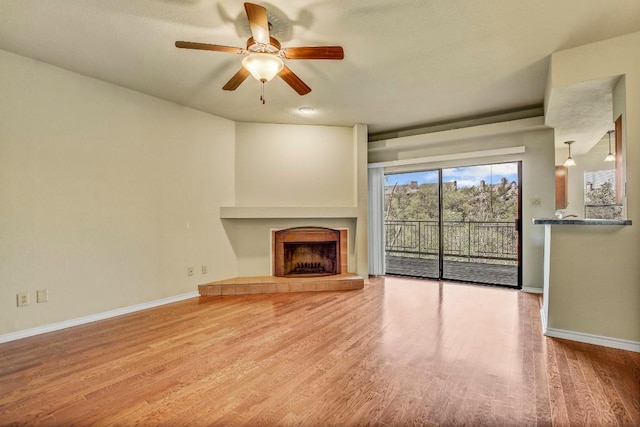 8200 Neely Dr Unit 116, Austin, TX 78759 - unfurnished living room featuring ceiling fan, wood finished floors, and a tile fireplace