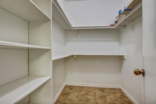 8200 Neely Dr Unit 116, Austin, TX 78759 - walk in closet featuring stone finish floors