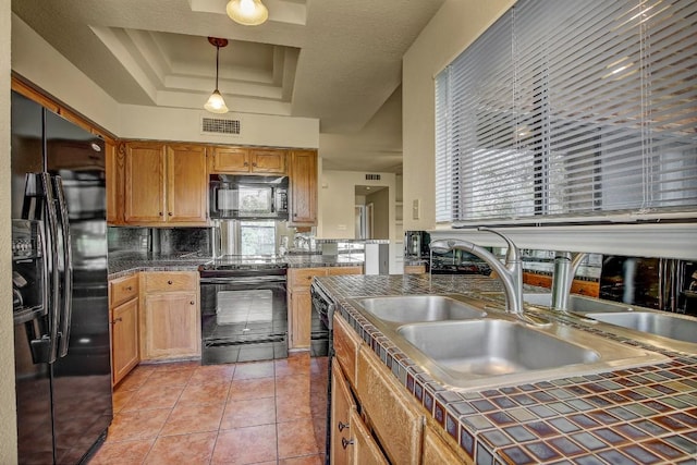 8200 Neely Dr Unit 116, Austin, TX 78759 - kitchen with black appliances, a tray ceiling, tile counters, decorative backsplash, and healthy amount of natural light