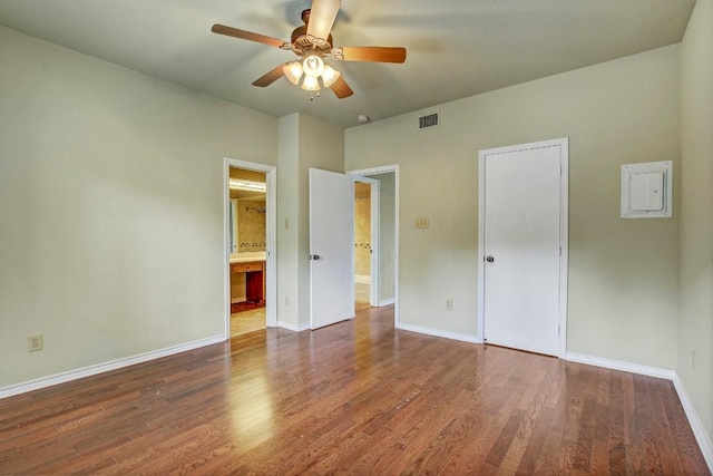 8200 Neely Dr Unit 116, Austin, TX 78759 - unfurnished bedroom with electric panel, wood finished floors, ensuite bathroom, and a ceiling fan