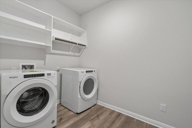 10406 Mager Ln, Hutto, TX 78634 - laundry area featuring washing machine and clothes dryer and wood finished floors