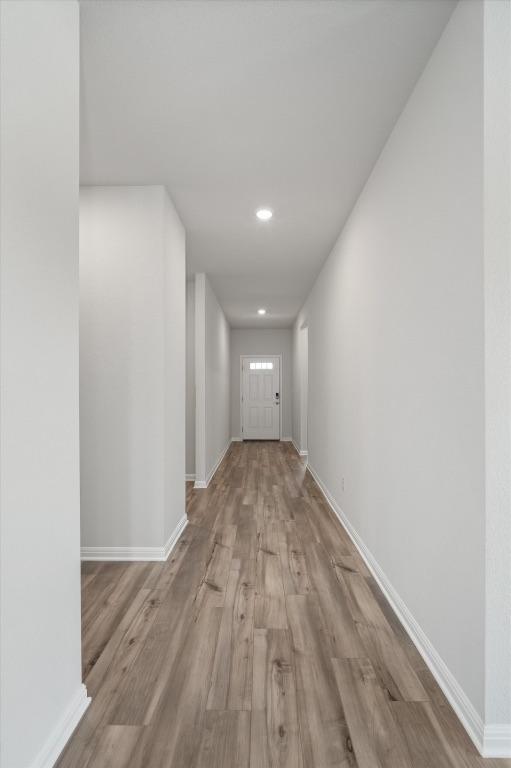10406 Mager Ln, Hutto, TX 78634 - hallway featuring wood finished floors and recessed lighting