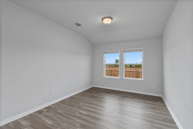 10406 Mager Ln, Hutto, TX 78634 - empty room featuring wood finished floors and vaulted ceiling