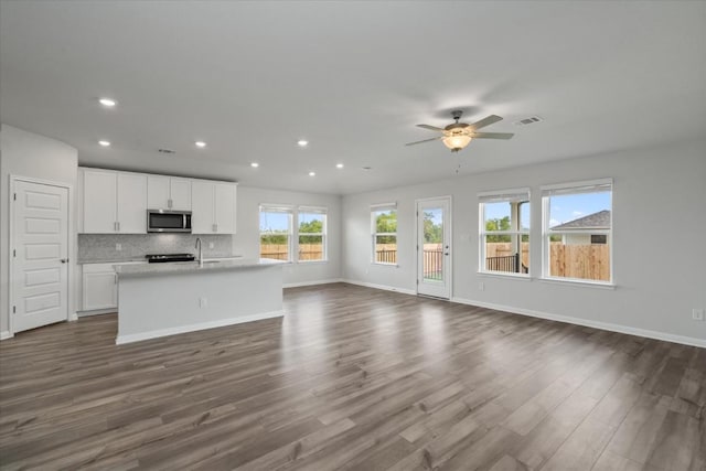 10406 Mager Ln, Hutto, TX 78634 - unfurnished living room with recessed lighting, dark wood finished floors, and ceiling fan