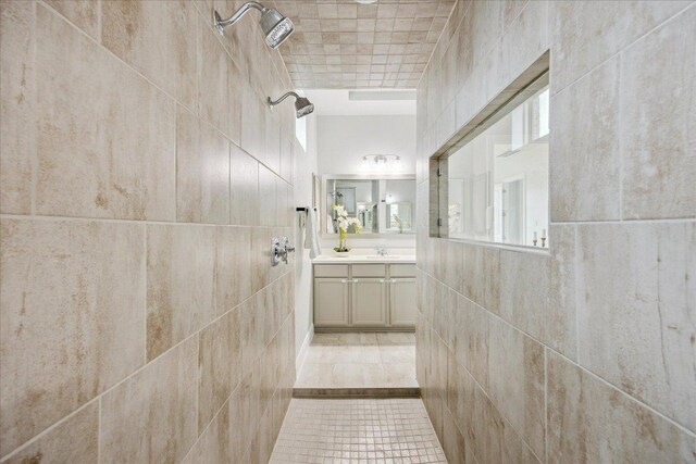 19612 Abigail Way, Pflugerville, TX 78660 - bathroom featuring vanity, tile patterned floors, and tile walls