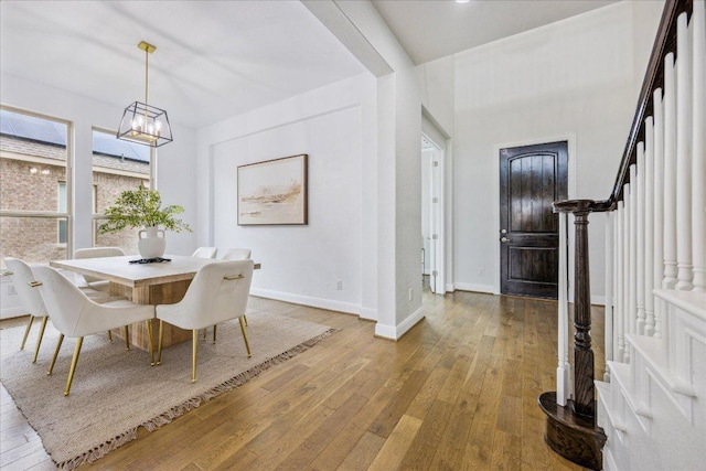 19612 Abigail Way, Pflugerville, TX 78660 - dining space with wood-type flooring, a chandelier, and stairway