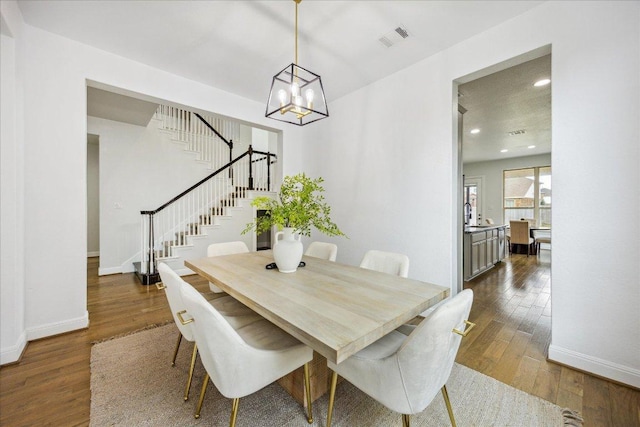 19612 Abigail Way, Pflugerville, TX 78660 - dining room with stairway, a chandelier, dark wood finished floors, and recessed lighting