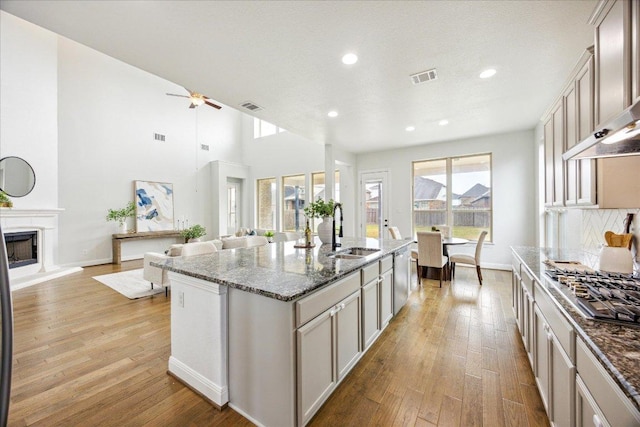 19612 Abigail Way, Pflugerville, TX 78660 - kitchen featuring stainless steel gas cooktop, light wood-style flooring, open floor plan, and recessed lighting