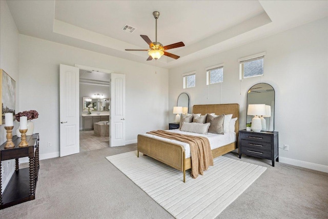 19612 Abigail Way, Pflugerville, TX 78660 - bedroom with a tray ceiling, light colored carpet, ensuite bath, and a ceiling fan