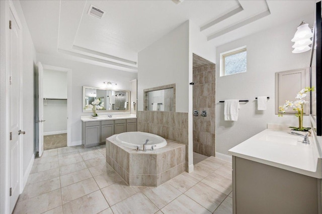 19612 Abigail Way, Pflugerville, TX 78660 - full bath featuring a tray ceiling, a bath, two vanities, a walk in shower, and tile patterned flooring