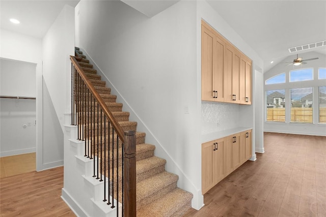 20500 Ed Townes Ter, Manor, TX 78653 - stairs featuring wood finished floors, a ceiling fan, vaulted ceiling, and recessed lighting