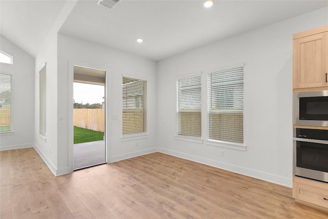 20500 Ed Townes Ter, Manor, TX 78653 - unfurnished dining area with light wood-style floors and recessed lighting