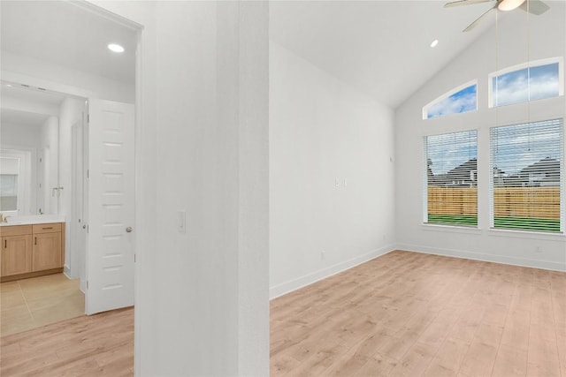 20500 Ed Townes Ter, Manor, TX 78653 - empty room with light wood finished floors, a ceiling fan, recessed lighting, and high vaulted ceiling
