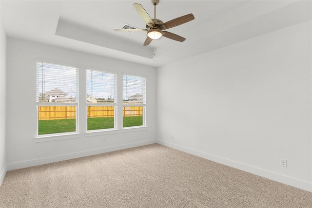 20500 Ed Townes Ter, Manor, TX 78653 - empty room featuring light carpet, a ceiling fan, and a raised ceiling