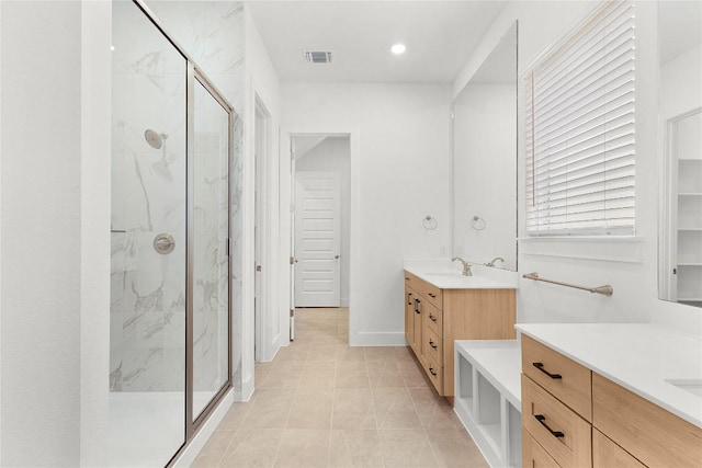 20500 Ed Townes Ter, Manor, TX 78653 - bathroom featuring a marble finish shower, two vanities, and recessed lighting