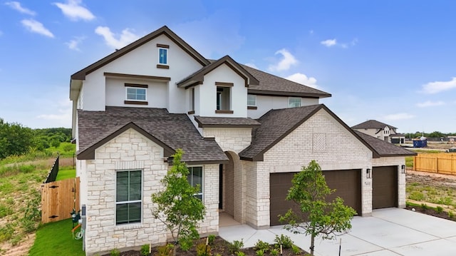 20500 Ed Townes Ter, Manor, TX 78653 - view of front of property with a shingled roof, a garage, concrete driveway, stone siding, and brick siding