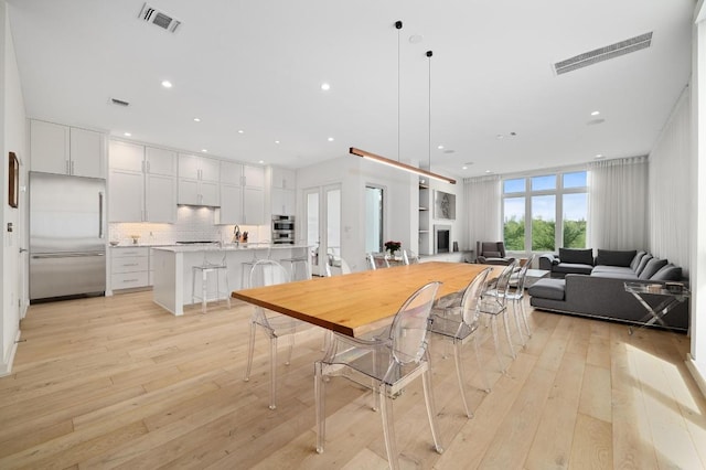 2608 Watkins Way, Austin, TX 78746 - dining room featuring light wood-type flooring and recessed lighting