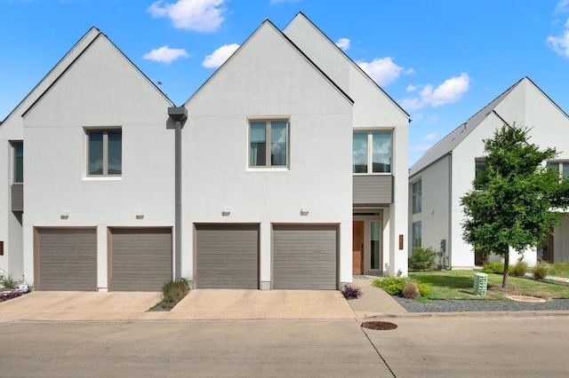 2608 Watkins Way, Austin, TX 78746 - view of front of home featuring stucco siding, concrete driveway, and an attached garage